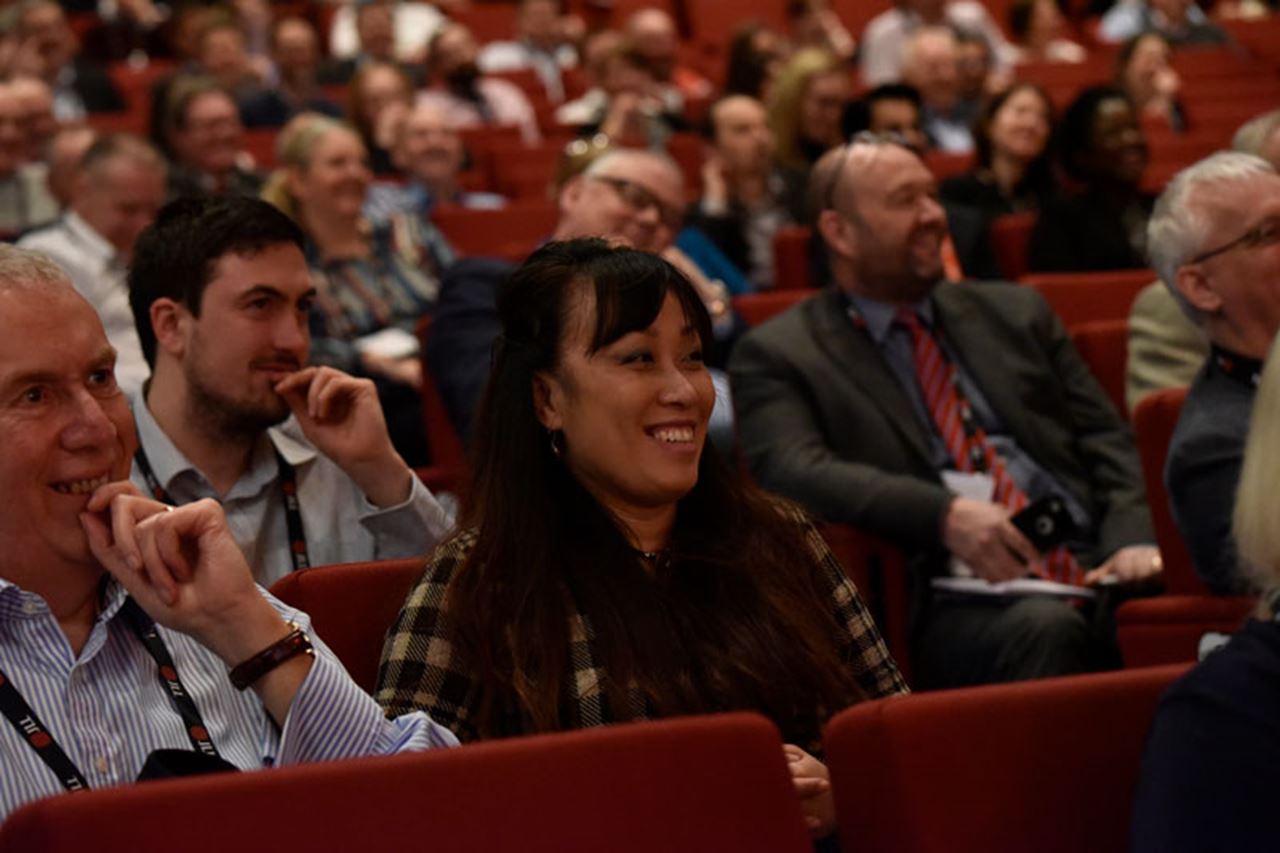 People seated looking amused