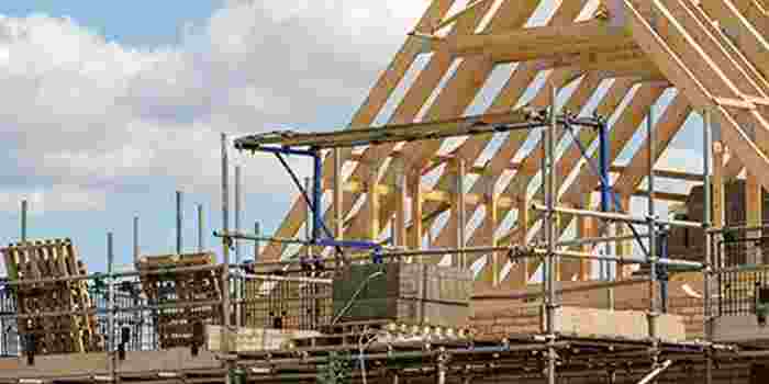 The pointed roof of a house being constructed