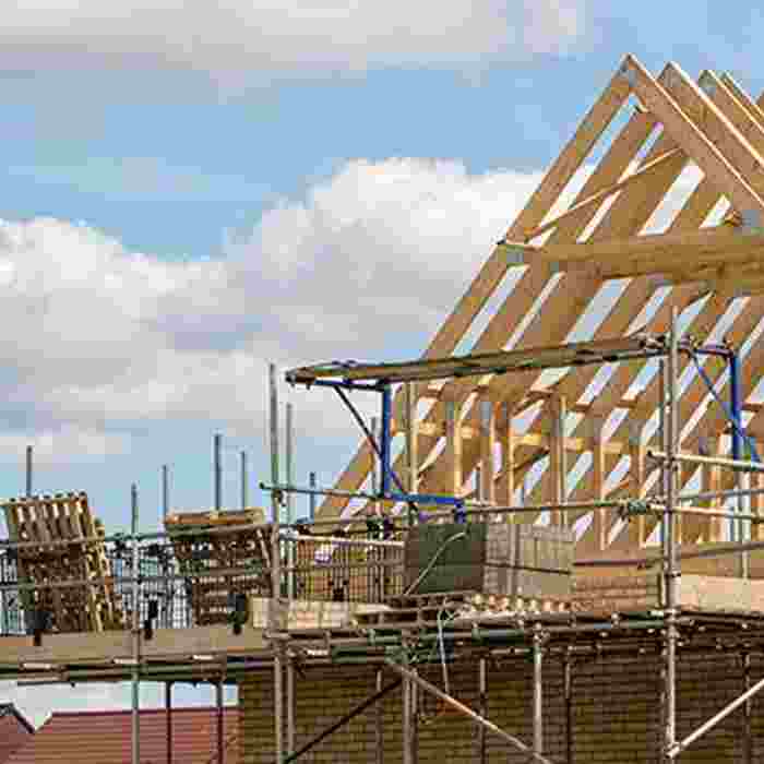 The pointed roof of a house being constructed