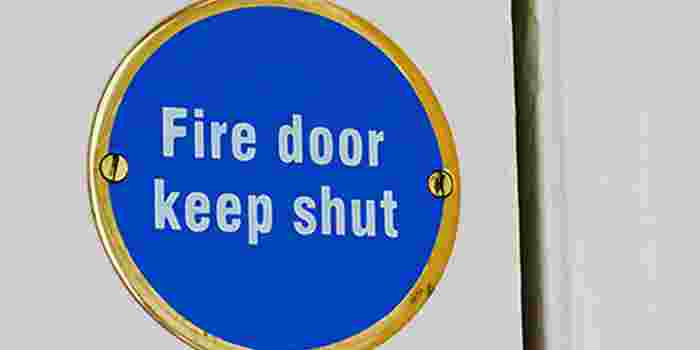 Fire door sign on white door.