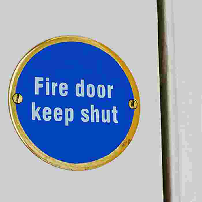 Fire door sign on white door.