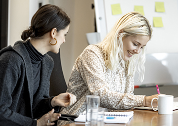 Staff talking and taking notes